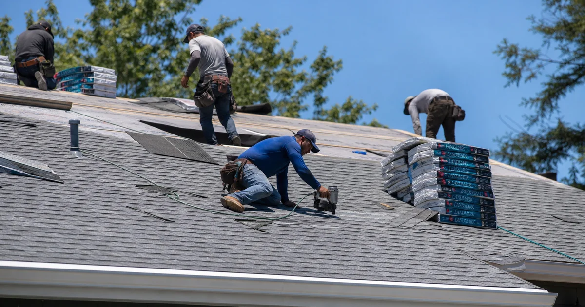Roofing crew installing shingles on a Hartford County home in late spring